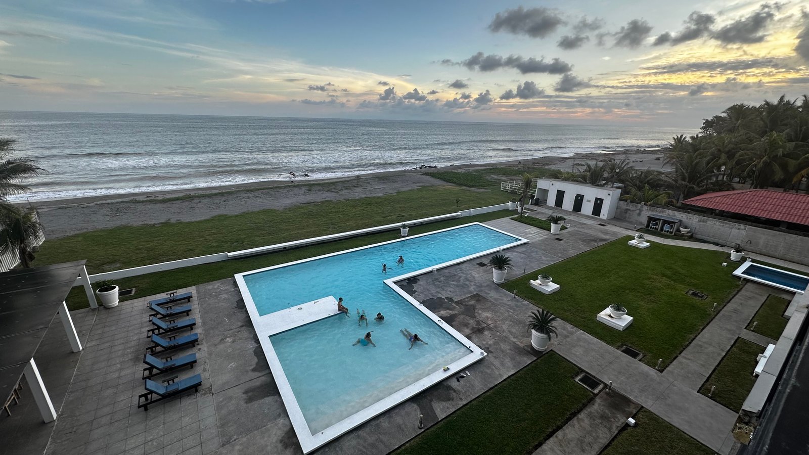 Wide panoramic sunset over pool and ocean